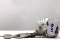 Last money in tin can close up, many silver and golden coins currency spread out on white table, hard times and inflation, Royalty Free Stock Photo