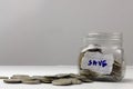 Last money in tin can close up, many silver and golden coins currency spread out on white table, hard times and inflation, Royalty Free Stock Photo