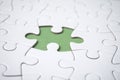 The last piece of jigsaw puzzle missing on green background to complete the mission Royalty Free Stock Photo