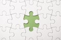 The last piece of jigsaw puzzle missing on green background to complete the mission Royalty Free Stock Photo