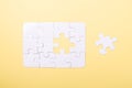 Last piece jigsaw White puzzle Concept success of business Yellow background Royalty Free Stock Photo