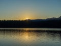 The last ray of a sunset lake above a forest lake Royalty Free Stock Photo