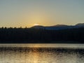 The last ray of a sunset lake above a forest lake Royalty Free Stock Photo