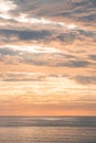 Last rays of the sun illuminate clouds flying across the sky and the reflection from the sea illuminates the surrounding cliffs. Royalty Free Stock Photo