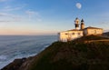 The last rays of the sun and the moon in the sky at the Atalaia lighthouse. Royalty Free Stock Photo