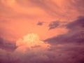 The last rays of the sun at sunset illuminate a cluster of clouds that breaks through Royalty Free Stock Photo