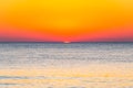 The last seconds of the amazing sundown behind the sea horizon. A bit of the sun star sphere showing up above the Tyrrhenian sea Royalty Free Stock Photo