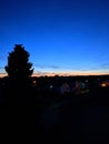 Last seconds of a sunset in loweraustria with a tree and Houses Royalty Free Stock Photo