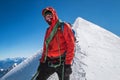 Last steps before Mont Blanc Monte Bianco summit 4808 m of rope team happy smiling man in climbing harness dressed red
