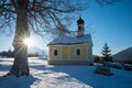 Last sun rays beside the tree, winter landscape with small chapel, Maria Rast Krun Royalty Free Stock Photo