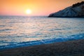 Last sunlight glowing azure waves of Ionian Sea. Great spring sunset view of Porto Katsiki Beach. Beautiful outdoor scene of Royalty Free Stock Photo