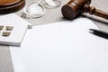 Last will and testament near house figure, glasses and gavel on light grey table, closeup Royalty Free Stock Photo