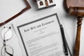 Last will and testament near house model, glasses, gavel on white table, flat lay Royalty Free Stock Photo