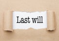 Last Will text appearing behind torn brown paper Royalty Free Stock Photo