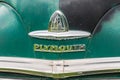 Chrome front bumper and name badge on a vintage Plymouth Super De Luxe automobile