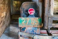 License plate on a rusted vintage Ford Model A pickup truck in a barn