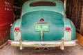 Vintage Plymouth Super De Luxe automobile parked in a barn