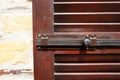 Latch on the wooden brown shutter.