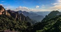 Late afternoon casts long shadows on the lush green pine trees with many mountain ranges fading towards the horizon in Huang Shan Royalty Free Stock Photo