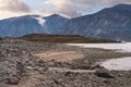 Late afternoon with soft clouds in the valley of Akshayuk pass, Baffin Island. Icebergs floating in the ocean of north