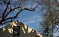 Late afternoon sun lighting up an old empty attic and two winter trees Royalty Free Stock Photo