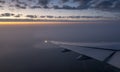 Late afternoon view of aircraft wing and setting sun Royalty Free Stock Photo