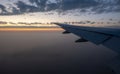 Late afternoon view of aircraft wing and setting sun Royalty Free Stock Photo