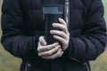 In late autumn, men`s hands are warming themselves on a black toggle switch with a hot drink. Environmentally friendly use of Royalty Free Stock Photo