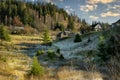 Late autumn in the mountains. A small village with wooden houses on the slopes of the mountains. che Royalty Free Stock Photo