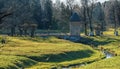 Late autumn view of two-storey circular Peel Tower with a thatched conical roof and bridge over small river in the State Museum-