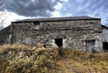 Old deserted stone barn, sitting under a cloudy sky in, Stainforth, Settle, UK