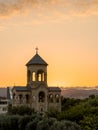 Late evening bright sunset sun rays enlighten through the small chapel arches near the Holy Trinity Cathedral of Tbilisi, Georgia