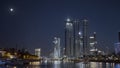 Late evening cityscape with Moscow city skyscrapers on dark blue night sky. Action. Beautiful river and glowing Royalty Free Stock Photo