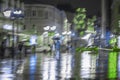 Late evening in the deserted city, lonely pedestrians rush home, Abstract blurred background. Bright illumination Royalty Free Stock Photo