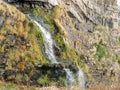 Late evening light falls on a small waterfall near Hartland Quay, on the Coastal Path. North Devon Uk. Royalty Free Stock Photo