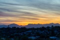 Late evening sunset with rolling hills and houses and palm trees on the ridge in the sonora desert of arizona wilderness Royalty Free Stock Photo