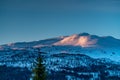 Late evening sunset in winter Lappland Mountains in Northern Sweden - frozen lake with and and bjork in the in the wild forest,