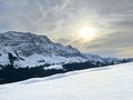 Late evening winter sun over the snow-covered slopes of the Alpstein mountain range and before dusk over massif of the Alps Royalty Free Stock Photo