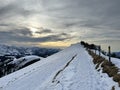 Late evening winter sun over the snow-covered slopes of the Alpstein mountain range and before dusk over massif of the Alps Royalty Free Stock Photo