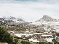 Late morning sun above sharp snowy Alpine cliffs