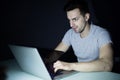 Late night internet addiction or working late man using laptop at a desk in the dark Royalty Free Stock Photo