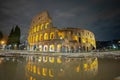 Late night view of the colosseum in Rome, rblue skies above the great famous amphitheatre. Autumn setting, visible reflection in