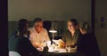 Late nights are a part of the job. Cropped shot of a group of businesspeople working together around a table in their Royalty Free Stock Photo