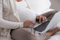 Late pregnant woman using laptop computer, consulting doctor online Royalty Free Stock Photo