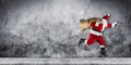 Late Santa claus in a hurry with traditional red white costume a Royalty Free Stock Photo