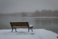 Snow covered bench on shore of George Wyth Lake