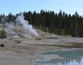 Late Spring in Yellowstone National Park: Black Growler Steam Vent with the Scummy Pool in the Foreground in the Porcelain Basin A Royalty Free Stock Photo