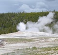 Spring in Yellowstone: Old Faithful Geyser Starting to Spout in the Old Faithful Historic District in the Upper Geyser Basin Area