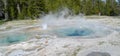 Late Spring in Yellowstone National Park: Spasmodic Geyser Erupts in the Sawmill Group in Upper Geyser Basin Royalty Free Stock Photo