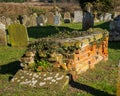 Late 18th century red brick tomb and other gravestones in church yard.